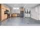 Kitchen and laundry area features stainless steel appliances and light-colored cabinets, and gray painted floor at 3447 Washington Blvd, Indianapolis, IN 46205