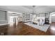 Spacious main bedroom with hardwood floors, built-in shelving, sitting area, and plenty of natural light at 3447 Washington Blvd, Indianapolis, IN 46205