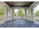 Expansive porch with ornate pillars offering stunning views of the surrounding greenery at 3447 Washington Blvd, Indianapolis, IN 46205
