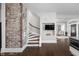 View of staircase with exposed brick wall and open floor plan at 3447 Washington Blvd, Indianapolis, IN 46205