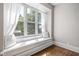 Comfortable window seat nook with natural light and two decorative pillows at 3447 Washington Blvd, Indianapolis, IN 46205