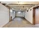 Unfinished basement with painted walls, exposed ceiling, and concrete floor provides ample storage space at 3470 N Kenwood Ave, Indianapolis, IN 46208