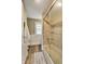 Bathroom featuring tub/shower, modern tiling, and wood-look flooring with a large towel hanging on wall at 3470 N Kenwood Ave, Indianapolis, IN 46208