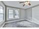 Bedroom featuring a ceiling fan, two windows providing lots of natural light, and neutral gray walls at 3470 N Kenwood Ave, Indianapolis, IN 46208