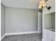 Bedroom with a sconce on the wall, gray carpet and walls, and white trim at 3470 N Kenwood Ave, Indianapolis, IN 46208