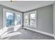 Bright bedroom with gray walls and carpet features three large windows for ample natural light at 3470 N Kenwood Ave, Indianapolis, IN 46208
