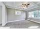 Bedroom featuring a coffered ceiling, neutral-toned carpet, and a large window at 3470 N Kenwood Ave, Indianapolis, IN 46208