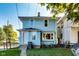 View of a two-story home with light blue siding, a well-maintained lawn, and mature trees at 3470 N Kenwood Ave, Indianapolis, IN 46208