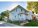 Charming two-story home featuring light blue siding, a well-kept lawn, and mature trees in a neighborhood at 3470 N Kenwood Ave, Indianapolis, IN 46208