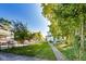 Well-maintained front yard with green grass, mature trees, and a charming home with a covered porch at 3470 N Kenwood Ave, Indianapolis, IN 46208