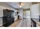 Well-lit kitchen featuring white cabinets, granite countertops, and black appliances at 3470 N Kenwood Ave, Indianapolis, IN 46208