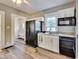 Charming kitchen with white cabinets, granite counters and black appliances at 3470 N Kenwood Ave, Indianapolis, IN 46208