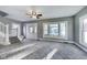 Spacious living room with staircase, neutral-toned carpet, and natural light at 3470 N Kenwood Ave, Indianapolis, IN 46208