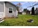 Spacious backyard with well-maintained lawn, shed, garden, and chain link fence at 3513 Berkdale Dr, Columbus, IN 47203