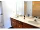 A traditional bathroom with a double vanity, large mirror, and ample lighting fixtures at 3513 Berkdale Dr, Columbus, IN 47203
