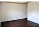 A bright, spacious bedroom with hardwood floors and a standard door for additional access at 3513 Berkdale Dr, Columbus, IN 47203