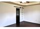 Spacious bedroom with a modern sliding door that leads to the bathroom, and rich, dark hardwood floors at 3513 Berkdale Dr, Columbus, IN 47203