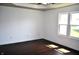Bright bedroom with hardwood flooring, tray ceiling and a large window for natural light at 3513 Berkdale Dr, Columbus, IN 47203