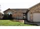 Charming single-story home with a brick facade, two-car garage, and well-manicured lawn at 3513 Berkdale Dr, Columbus, IN 47203