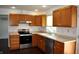 Well-appointed kitchen with stainless steel appliances, light countertops and wooden cabinets at 3513 Berkdale Dr, Columbus, IN 47203