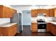 Spacious kitchen with stainless steel appliances, light countertops, stainless steel refrigerator, and wood cabinetry at 3513 Berkdale Dr, Columbus, IN 47203