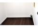 A compact laundry room with dark hardwood flooring and utility connections at 3513 Berkdale Dr, Columbus, IN 47203