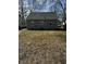 A view of the backyard of a single-Gathering home featuring a grassy lawn and mature trees at 3521 N Rural St, Indianapolis, IN 46218