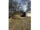 A backyard view showing a detached garage, lawn, and some trees at 3521 N Rural St, Indianapolis, IN 46218