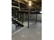 Unfinished basement with painted concrete floor, black stairs, and utilities at 3521 N Rural St, Indianapolis, IN 46218
