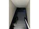 Stairwell to basement, showing gray painted steps and gray walls at 3521 N Rural St, Indianapolis, IN 46218