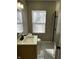 A well-lit bathroom features a shower, vanity, and light-colored tiles at 3521 N Rural St, Indianapolis, IN 46218
