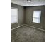 This bedroom features neutral-colored walls and floors, and updated windows with blinds at 3521 N Rural St, Indianapolis, IN 46218