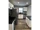 Kitchen featuring stainless steel appliances, white cabinets, dark countertops, and wood floors at 3521 N Rural St, Indianapolis, IN 46218
