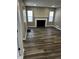 A naturally lit living room is shown with neutral paint, wood floors, and a fireplace at 3521 N Rural St, Indianapolis, IN 46218