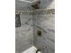 The elegant shower features marble-look tile, a mosaic tile border, and gold fixtures at 3521 N Rural St, Indianapolis, IN 46218