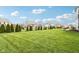 Lush green backyard offering plenty of space for activities and a charming patio area for relaxation and entertaining at 3645 Conifer Dr, Zionsville, IN 46077