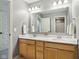 A clean bathroom features a double sink vanity and view to the shower at 3645 Conifer Dr, Zionsville, IN 46077
