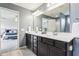 A primary bathroom showcases a double vanity with sleek countertops and leads to a bedroom at 3645 Conifer Dr, Zionsville, IN 46077