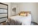 Bright bedroom features a comfortable bed, decorative pillows, and an open doorway leading to other rooms at 3645 Conifer Dr, Zionsville, IN 46077
