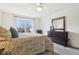 A sunny bedroom offers a ceiling fan and view to the backyard at 3645 Conifer Dr, Zionsville, IN 46077