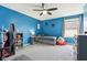 Cozy bedroom featuring blue walls, carpet floors, ceiling fan, and daybed with built-in storage at 3645 Conifer Dr, Zionsville, IN 46077