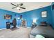 Stylized bedroom with blue walls, neutral carpet, ceiling fan, desk, and daybed with built-in storage at 3645 Conifer Dr, Zionsville, IN 46077