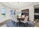Bright dining room features a modern chandelier and classic wooden hutch for a refined look at 3645 Conifer Dr, Zionsville, IN 46077