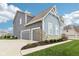 Three-car garage complements this home's stylish gray siding and stone accents at 3645 Conifer Dr, Zionsville, IN 46077