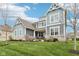 Charming curb appeal with blue siding, a manicured lawn, and a cozy front porch at 3645 Conifer Dr, Zionsville, IN 46077