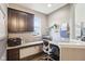 Home office with built-in desk, storage, and ample natural light at 3645 Conifer Dr, Zionsville, IN 46077