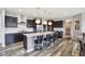 Modern kitchen with a large island, stainless steel appliances, and dark cabinetry for a sleek feel at 3645 Conifer Dr, Zionsville, IN 46077