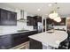 Modern kitchen featuring stainless steel appliances, sleek countertops, and dark cabinetry at 3645 Conifer Dr, Zionsville, IN 46077