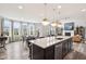 Open concept kitchen and living area with large island, fireplace, and ample natural light at 3645 Conifer Dr, Zionsville, IN 46077