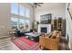 Bright living room boasts high ceilings, large windows, and a cozy fireplace for relaxation at 3645 Conifer Dr, Zionsville, IN 46077
